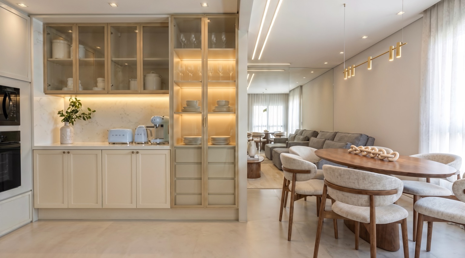 Kitchen open to the dining room, with a lit glass cabinet, round wooden table and upholstered chairs, rendered with Vizai